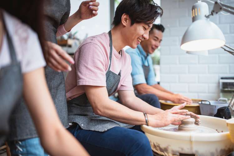 people molding clay with pottery wheel in pottery classes in Houston